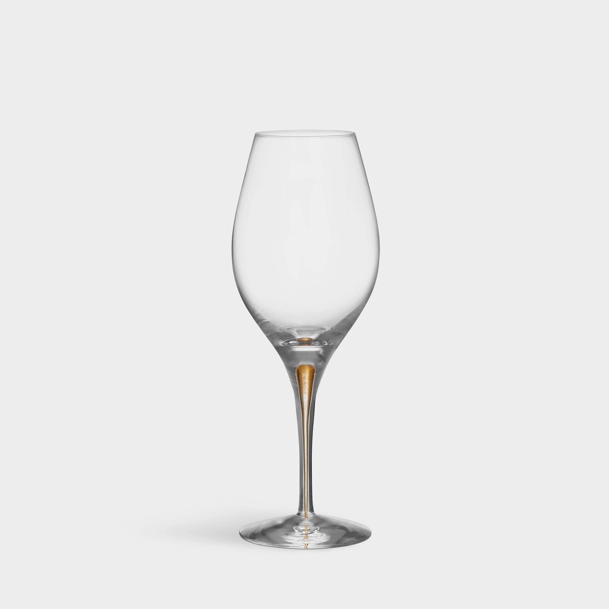 The Orrefors: Intermezzo Gold Balance Glass 14.8oz (2-Pack) features an elegant gold-tinted stem that exemplifies the series charm, enhancing any table setting against a plain white backdrop with its balanced design and craftsmanship.