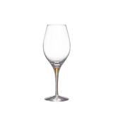 An empty Orrefors Intermezzo Gold Balance wine glass, 14.8oz, with a tall stem and rounded bowl, isolated on a white background.
