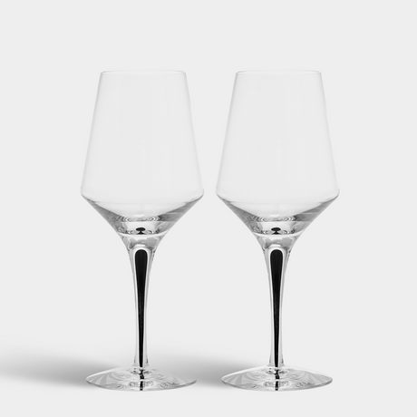 Two Orrefors Metropol White Wine Glasses with black stems (13.5oz, designed by Erika Lagerbielke) are side by side on a plain white background.