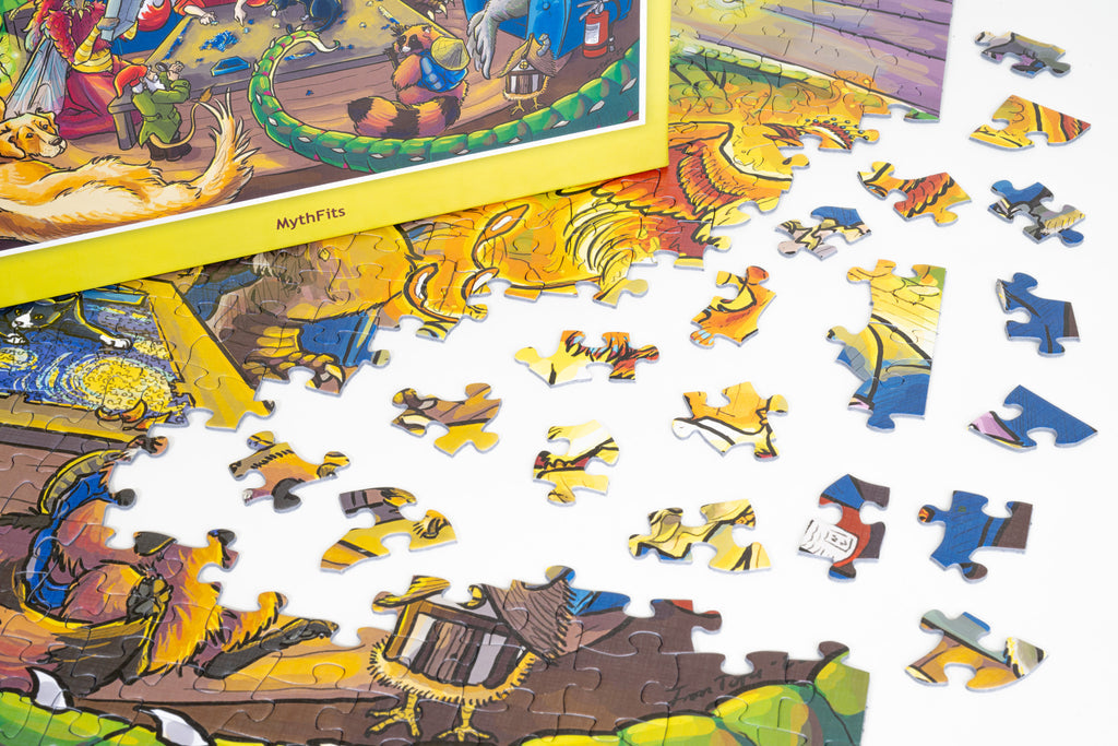 Partially assembled PuzzleTwist Something's Amiss! MythFits 500-piece jigsaw puzzle by artist Sophie Koch, with loose pieces on a white surface, showing a colorful fantasy scene with a dragon and characters.