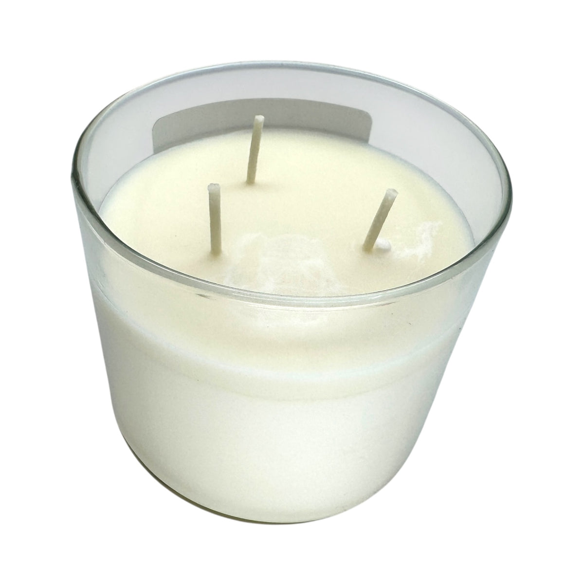 The Candle: Nordic Balsam - Winter Forest Candle is a white soy blend candle with three wicks in a clear glass container, displayed from above on a white background.