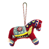 Red felted wool Swedish Dala Horse ornament with colorful embroidered patterns, a decorative saddle, and a striped hanging loop attached to the top.