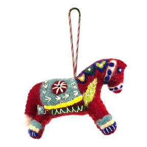 Red felted wool Swedish Dala Horse ornament with colorful embroidered patterns, a decorative saddle, and a striped hanging loop attached to the top.