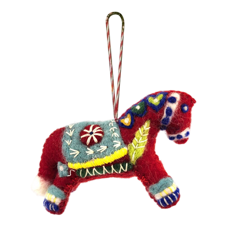 Red felted wool Swedish Dala Horse ornament with colorful embroidered patterns, a decorative saddle, and a striped hanging loop attached to the top.