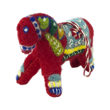 Small red felted wool ornament in the shape of a Swedish Dala Horse, decorated with green, blue, yellow, and white embroidered patterns.