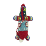 Handmade felt animal ornament with colorful woven patterns and yarn decoration, shaped like a Dala horse or alpaca, displayed on a white background.