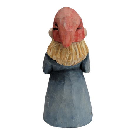 A hand-carved figurine portrays a woman holding a flower.