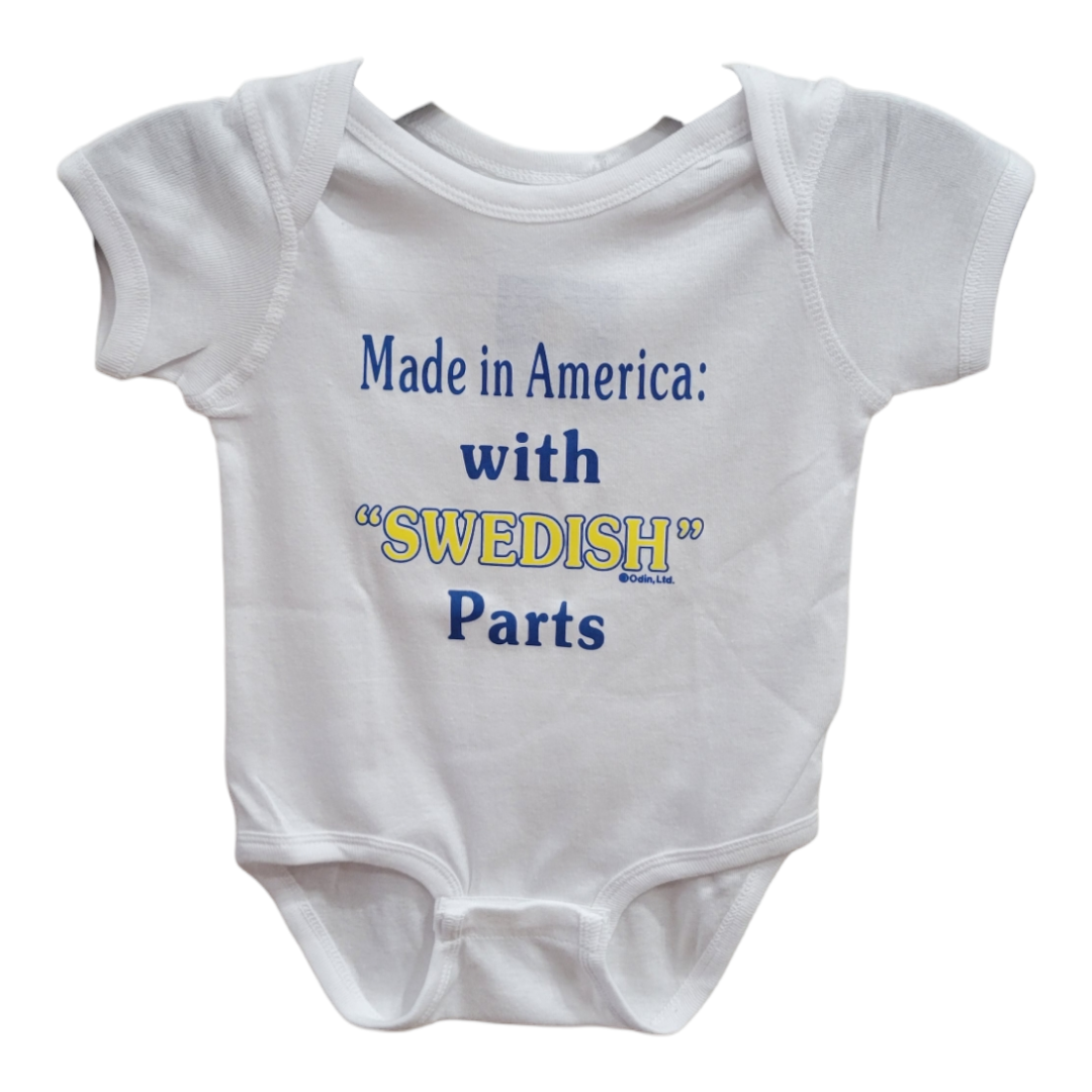 White baby onesie titled "Sweden Made in America with Swedish Parts," embellished with the text and a touch of Sweden flag colors.