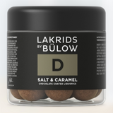 A 125g jar of Lakrids by Bülow #D Salt & Caramel features Danish chocolate-coated licorice candies, gluten-free, with a black label and round treats visible inside.