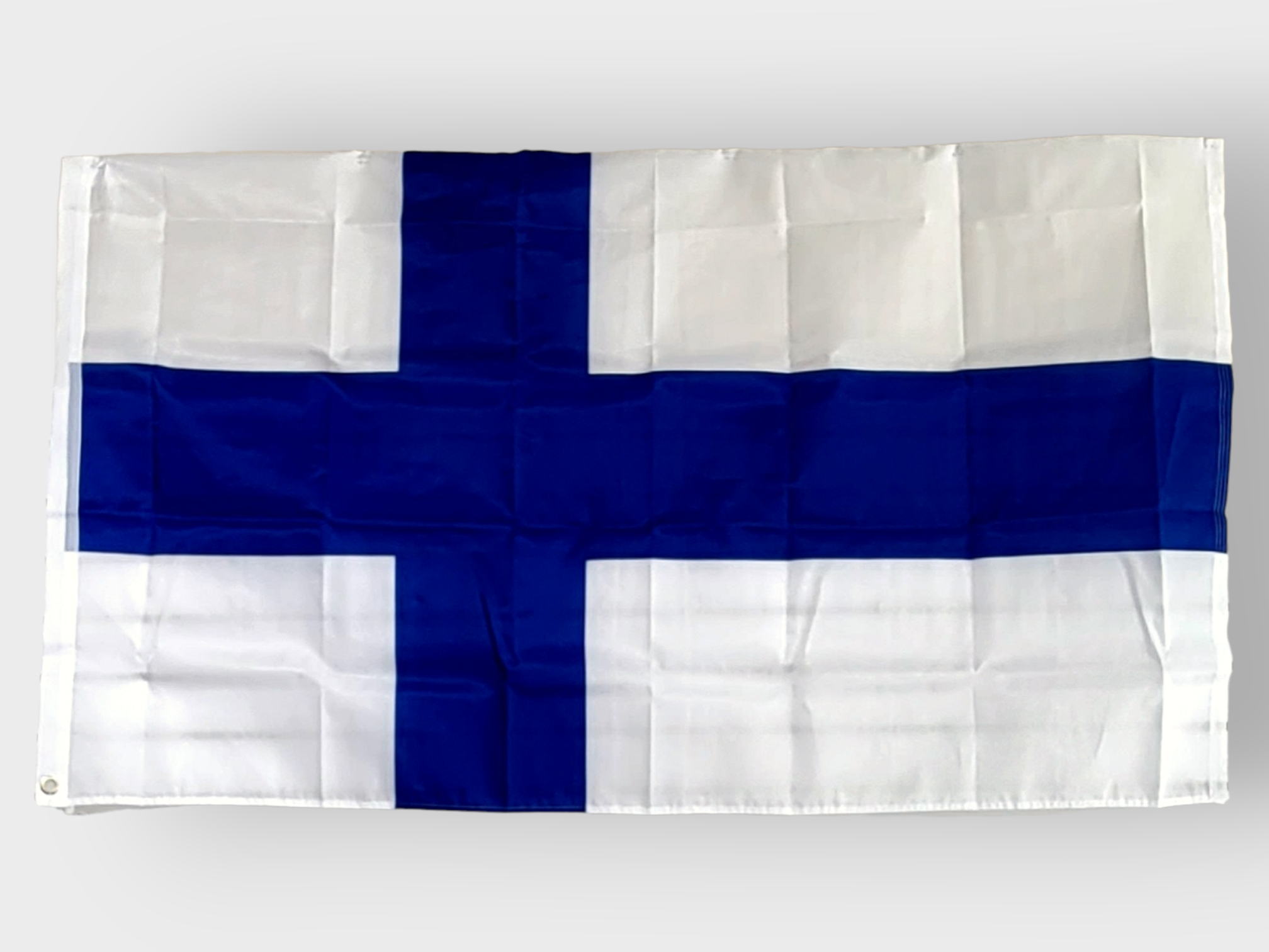 The Flag: Finland Polyester (3'x5') features a blue Nordic cross on a white background, crafted from durable polyester fabric. This flag is designed to be weather-resistant, ensuring long-lasting display and vibrant colors.