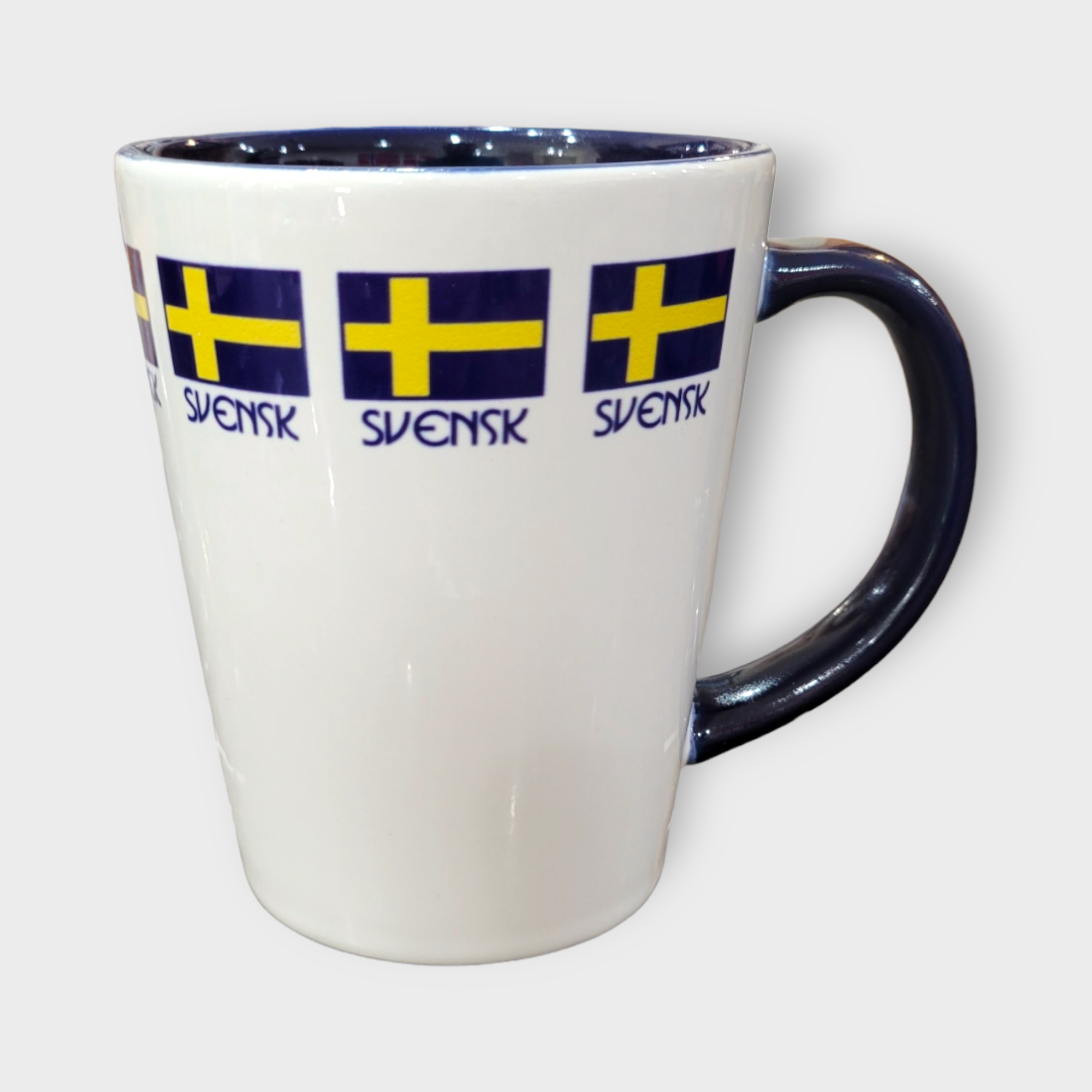 Display your pride with the 12oz "Svensk" Swedish Flag Latte Style Mug, featuring multiple Swedish flags and “SVENSK” in blue. This stylish, dishwasher-safe mug is ideal for daily use or as a unique gift.