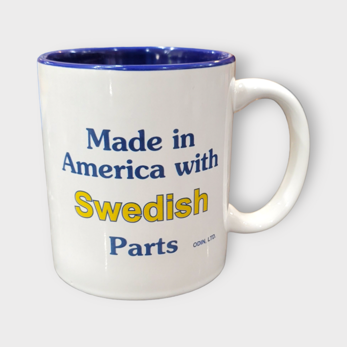 11oz ceramic mug featuring the text "Made in America with Swedish Parts" in vibrant blue and yellow, complemented by a blue interior.
