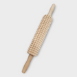 The Knobbed Swedish Rolling Pin, with its wooden construction and textured surface featuring pyramid-shaped spikes, is displayed on a white background, ideal for crafting kruskavel or traditional knäckebröd.
