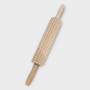 The Knobbed Swedish Rolling Pin, with its wooden construction and textured surface featuring pyramid-shaped spikes, is displayed on a white background, ideal for crafting kruskavel or traditional knäckebröd.