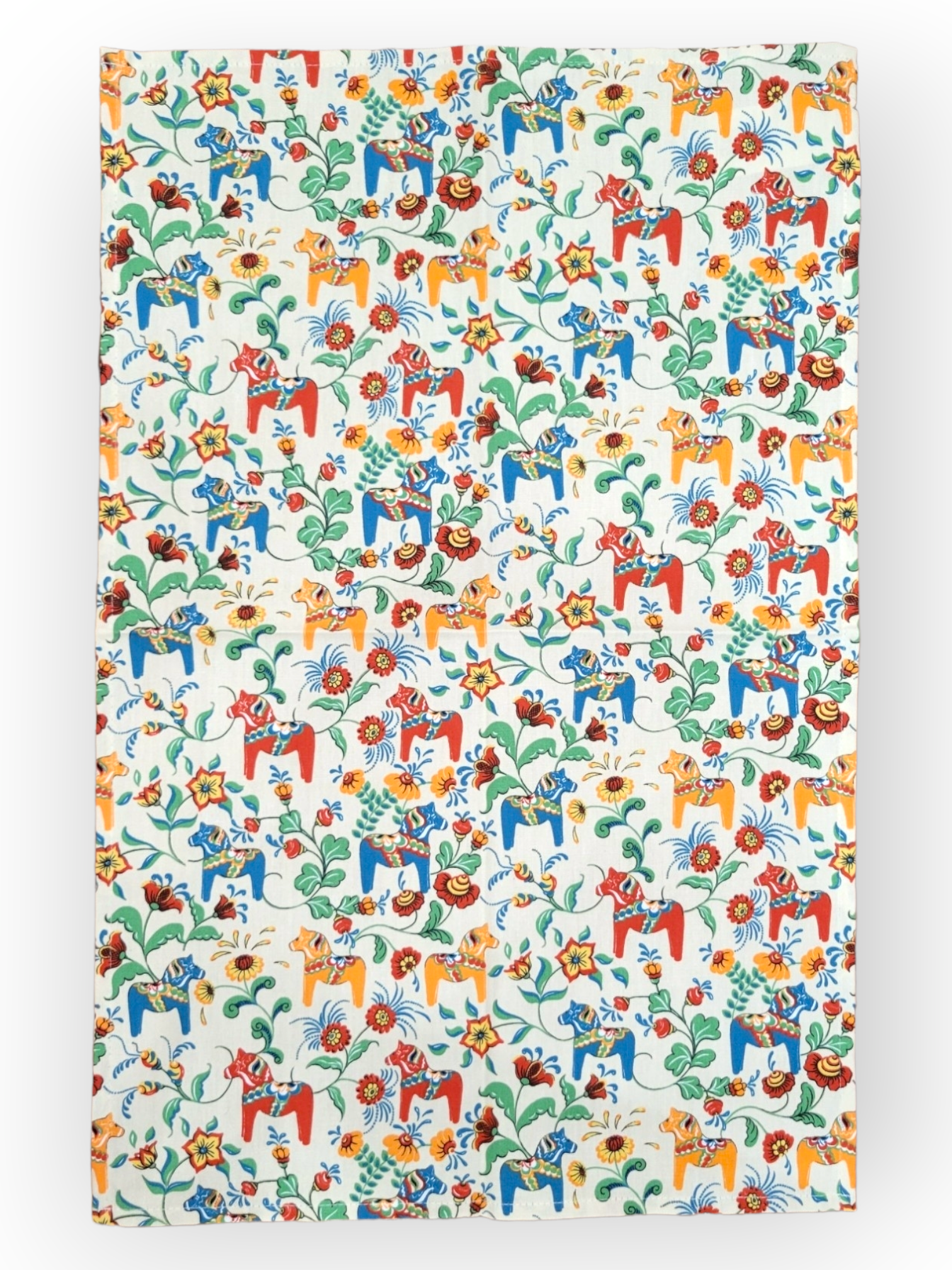 The tea towel features a lively Leksand Mini Swedish Dala Horse pattern with colorful illustrations in red, yellow, blue, and green on white, celebrating Swedish tradition. Available in 4 color options.