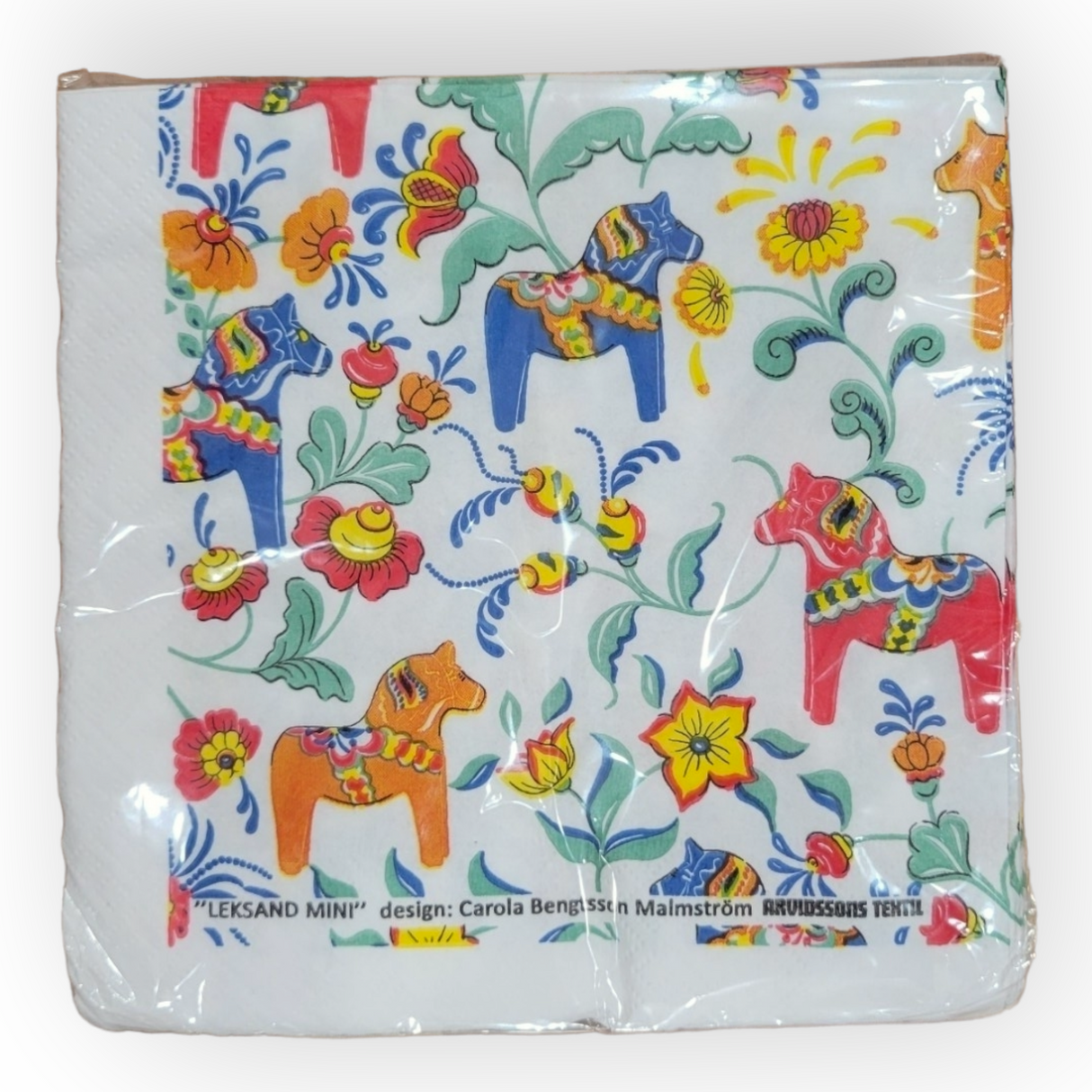 Pack of Napkins: Leksand Mini Dala Cream featuring a decorative design with colorful Dala horses, vibrant Swedish flowers, and elegant Swedish text at the bottom.