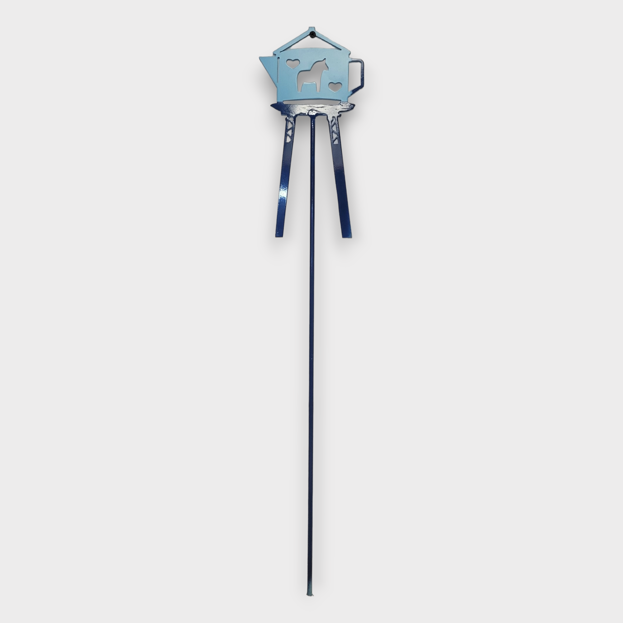 A striking blue metal pole features a charming water tower design embellished with hearts and a dala horse silhouette, set against a plain white background.