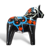 The Dala Horse: Black showcases Swedish traditional craftsmanship with its blue and red decorative patterns, set against a white background.