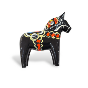 The Dala Horse: Black is a traditional Swedish handcraft, featuring a black painted wooden horse figurine adorned with colorful patterns of swirls and dots in red, yellow, and white.