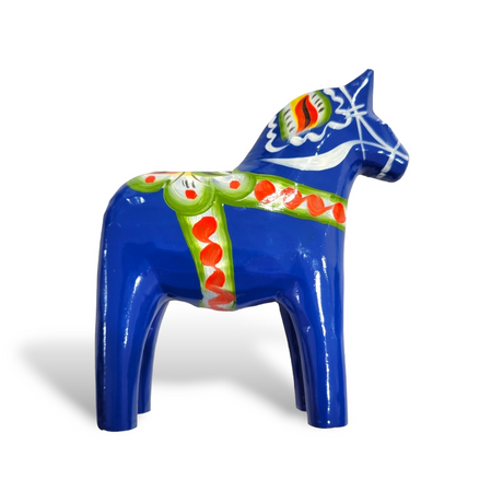 The Royal Blue Swedish Dala Horse with multi-color trim, showcasing intricate green and red patterns, is a skillfully hand-carved figurine viewed from the side, proudly made in Sweden.