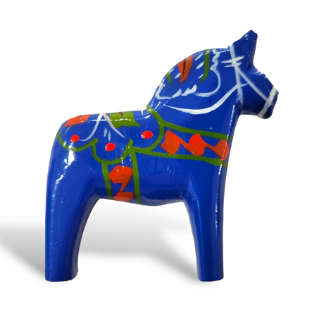 A small, hand-carved Royal Blue Swedish Dala Horse with multi-color trim stands against a white background. Made in Sweden.