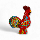 A lively Dala Rooster in red features intricate painted patterns, capturing the essence of Swedish handcraft.