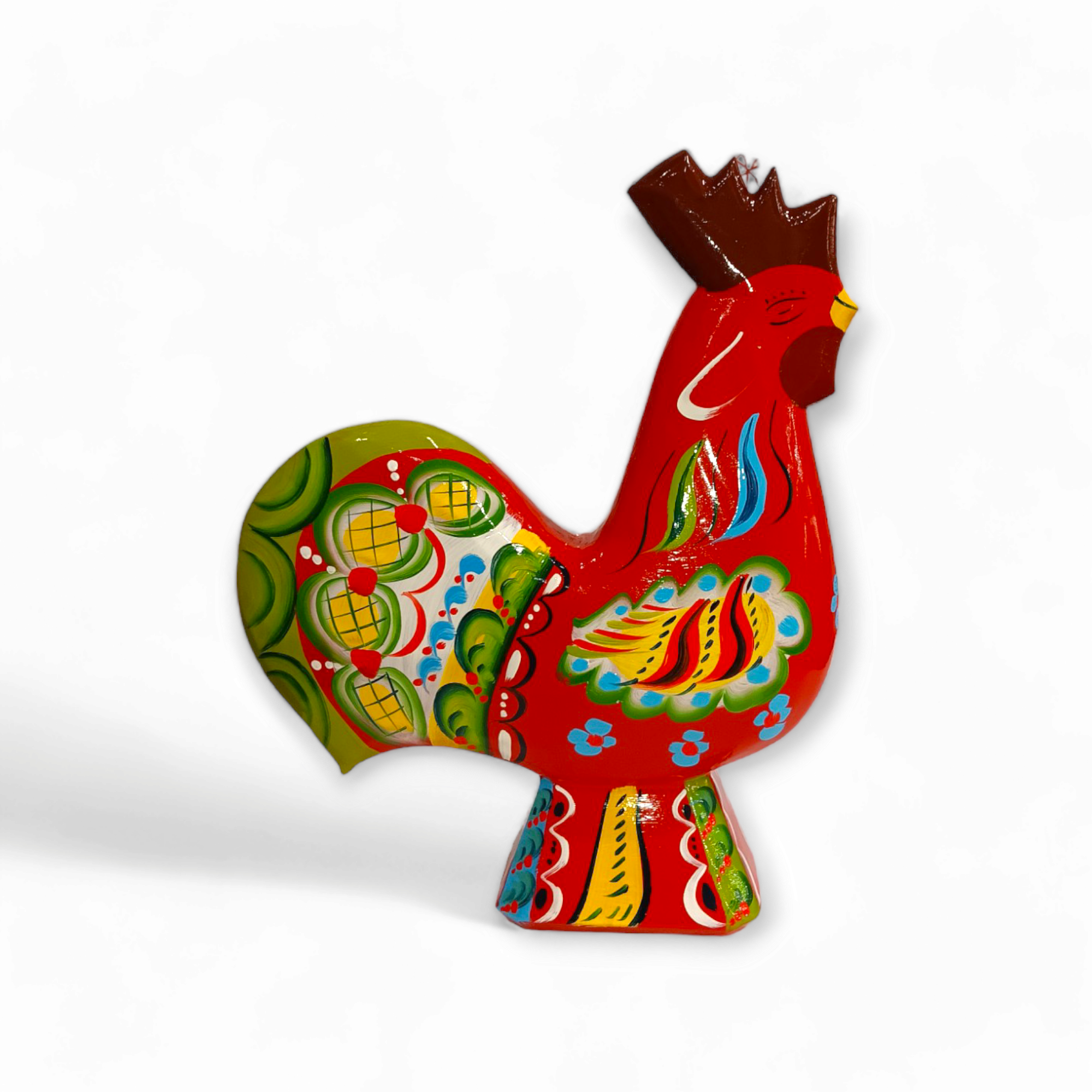 The Dala Rooster: Red, a ceramic piece with vibrant colors and intricate patterns reminiscent of traditional Swedish handcraft, stands out against a white background.