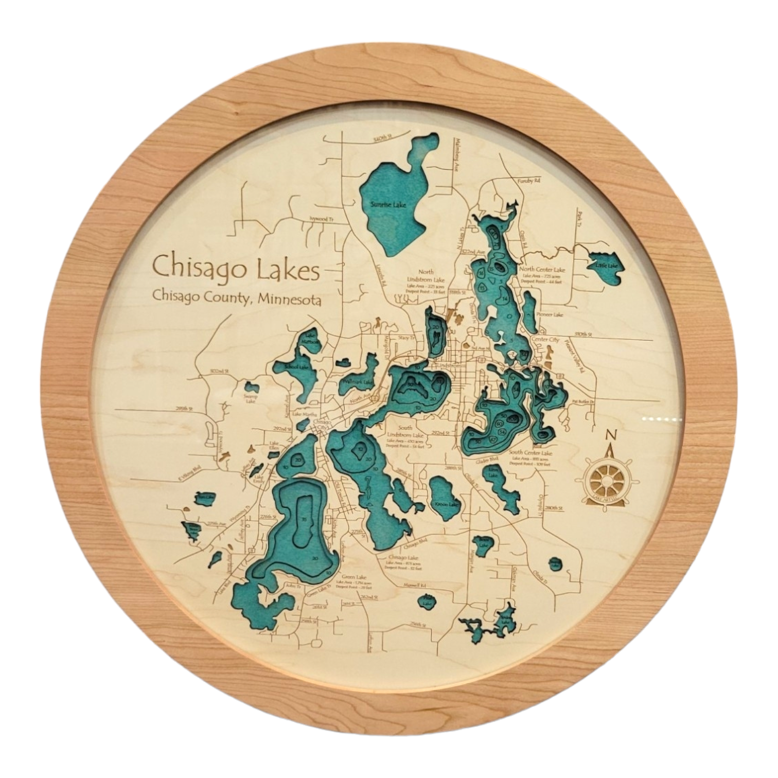 The Lake Map: Round Chisago Lakes Map showcases Chisago Lakes in Chisago County, Minnesota—America's Little Sweden—with blue lakes and detailed engravings in a round wooden frame.
