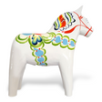 The Dala Horse: White Base with Multi-Color Trim Swedish Dala Horse is a white ceramic figurine, featuring vibrant patterns in blue, green, and red on a pristine white background.