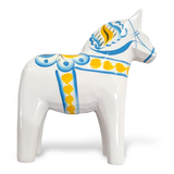 This white ceramic Dala Horse from the Swedish Flag Series features blue and yellow kurbits patterns, exemplifying exquisite Swedish craftsmanship.