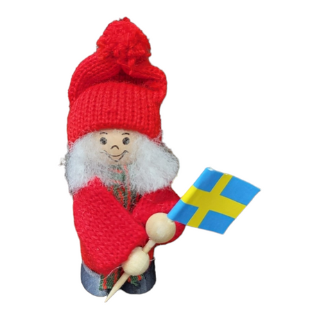 A small handcrafted Santa figurine, dressed in a red knit outfit and holding a wooden stick adorned with a Swedish flag, is available as Figurine: Santa with Swedish Flag - Boy or Girl 3 Tall.