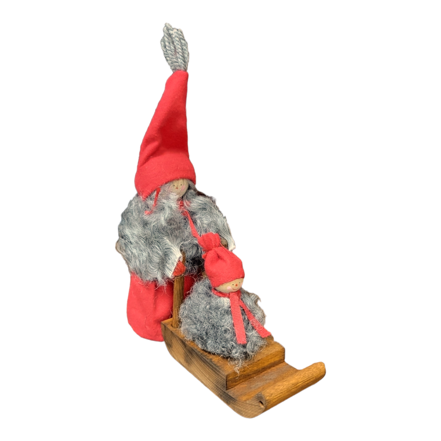 The "Santa Girl with Sled & Baby" figurine set features two charming wooden gnome figures, complete with red hats and gray beards, sitting on a wooden sled. Handcrafted in Sweden, these delightful pieces bring a touch of Nordic whimsy to your Christmas decorations.