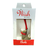 An ornament named Birki - Anja's Husky Puppy from The Wish Books, featuring a dog with a red ribbon nestled in a box, perfect for adding a touch of Christmas magic, as if crafted by Santa's Elves themselves.