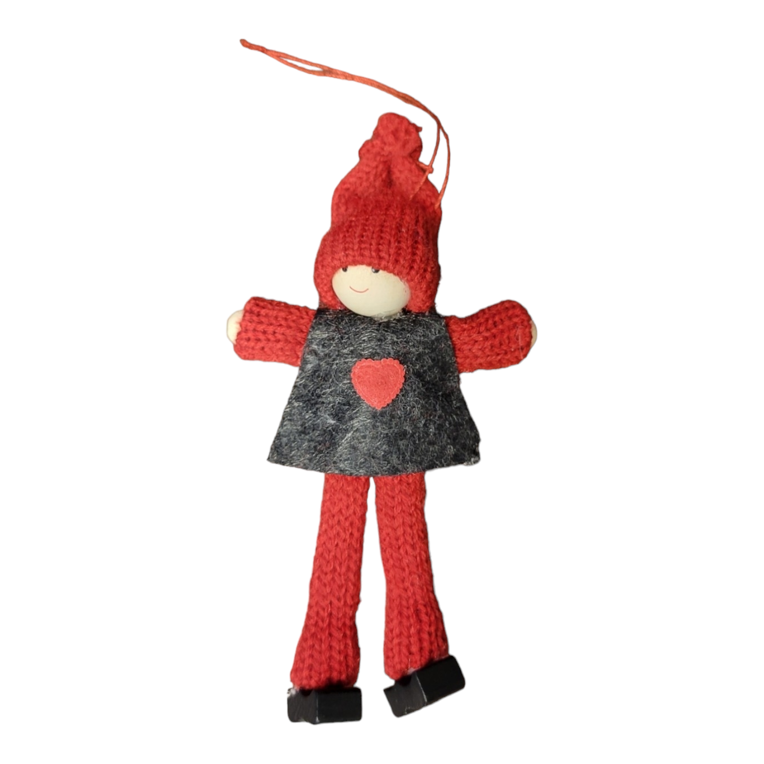 Ornament: Boy with a red and black knitted outfit featuring a wooden head, hands, and shoes, adorned with a heart on its shirt. This figurine sports a striking red knit hat, set against a white background.