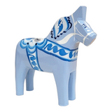 A hand-carved and painted Dala Horse in baby blue or pink, made in Sweden from pine, features traditional patterns—ideal for nursery decor or collectors of Swedish Dala horses.