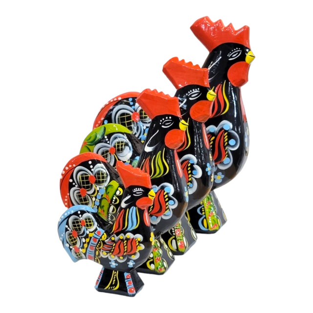 Four decorative Dala Rooster figurines, each featuring vibrant red, yellow, and floral details, are arranged in a line. These intricately patterned pieces highlight the beauty of Swedish traditional handcraft with their hand-carved elegance.