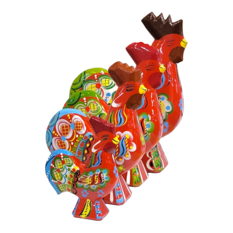 Four Dala Roosters: Red are lined up in a row, each boasting ornate patterns and vibrant colors dominated by red, green, and blue, reminiscent of traditional Swedish handcraft.