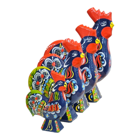 Four vibrant Dala Rooster figurines, reminiscent of Swedish handcraft, feature intricate floral and geometric patterns in primarily blue, red, and green. Their design captures the charm of traditional Dala roosters.