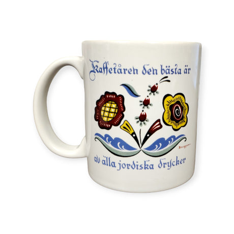 11oz ceramic mug featuring a vibrant floral pattern and Swedish text, Kaffetåren den bästa är av alla jordiska drycker, showcasing stylized Swedish flowers.