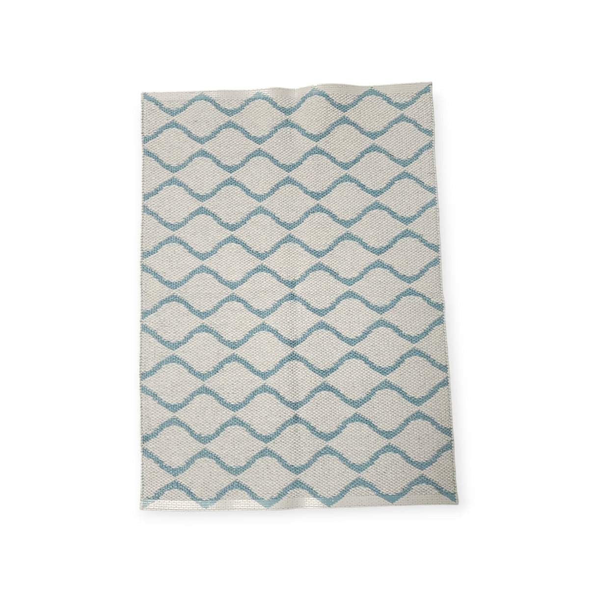The Rug: Wave Blue features a geometric zigzag pattern in blue and white, crafted from durable Swedish vinyl, ensuring lasting appeal.