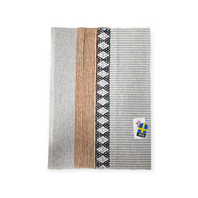 A rug with vertical stripes in gray, tan, and black patterns, featuring a Horredsmattan Swedish-themed tag in the corner, named Rug: Savanne Light Grey Vinyl.