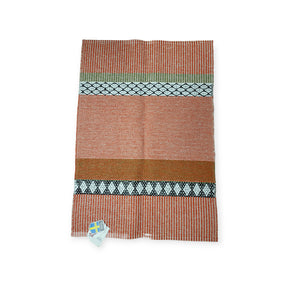 The Horredsmattan Savanne vinyl rug features reddish orange, beige, white, black, and green geometric stripes in a rectangular woven design, shown flat with a tag at the bottom left corner.