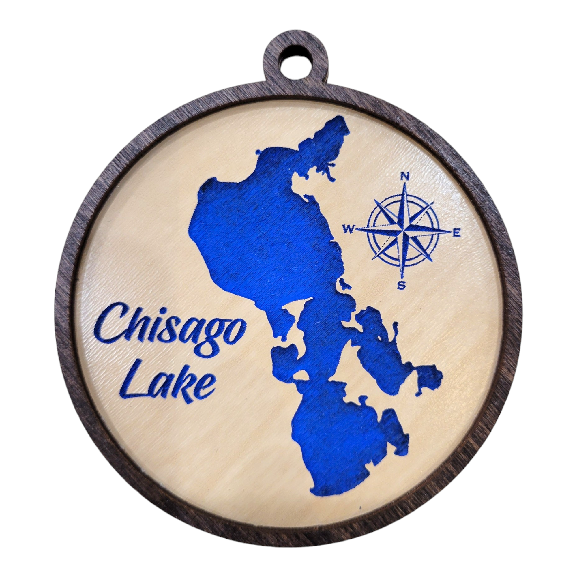 This round etched wood ornament, named "Ornament: Chisago Lake," beautifully features a 3 1/2-inch blue map of Chisago Lake, complete with a compass rose design, adding a touch of rustic charm to any decor.