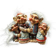 A delightful set of four Norwegian troll dolls, made from resin with white hair and traditional attire, captures the essence of collectable charm.