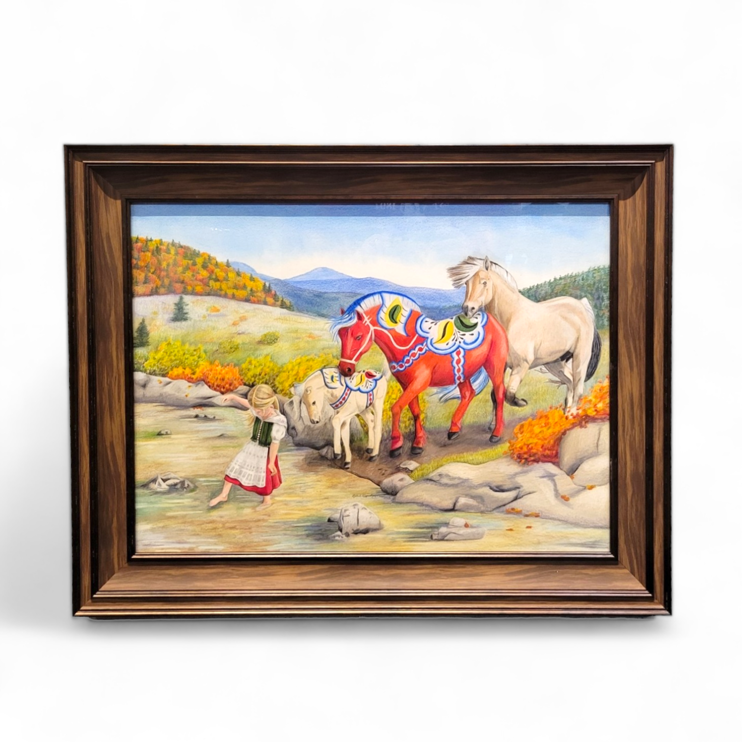 Introducing the original artwork "Following the Leader" by Rachael Koppendrayer. This 29x23 framed piece features a girl leading a red decorative horse, a goat, and a white horse through a vibrant autumn landscape, complete with mountains in the backdrop. The charm of nature is captured beautifully in this exquisite colored pencil drawing.