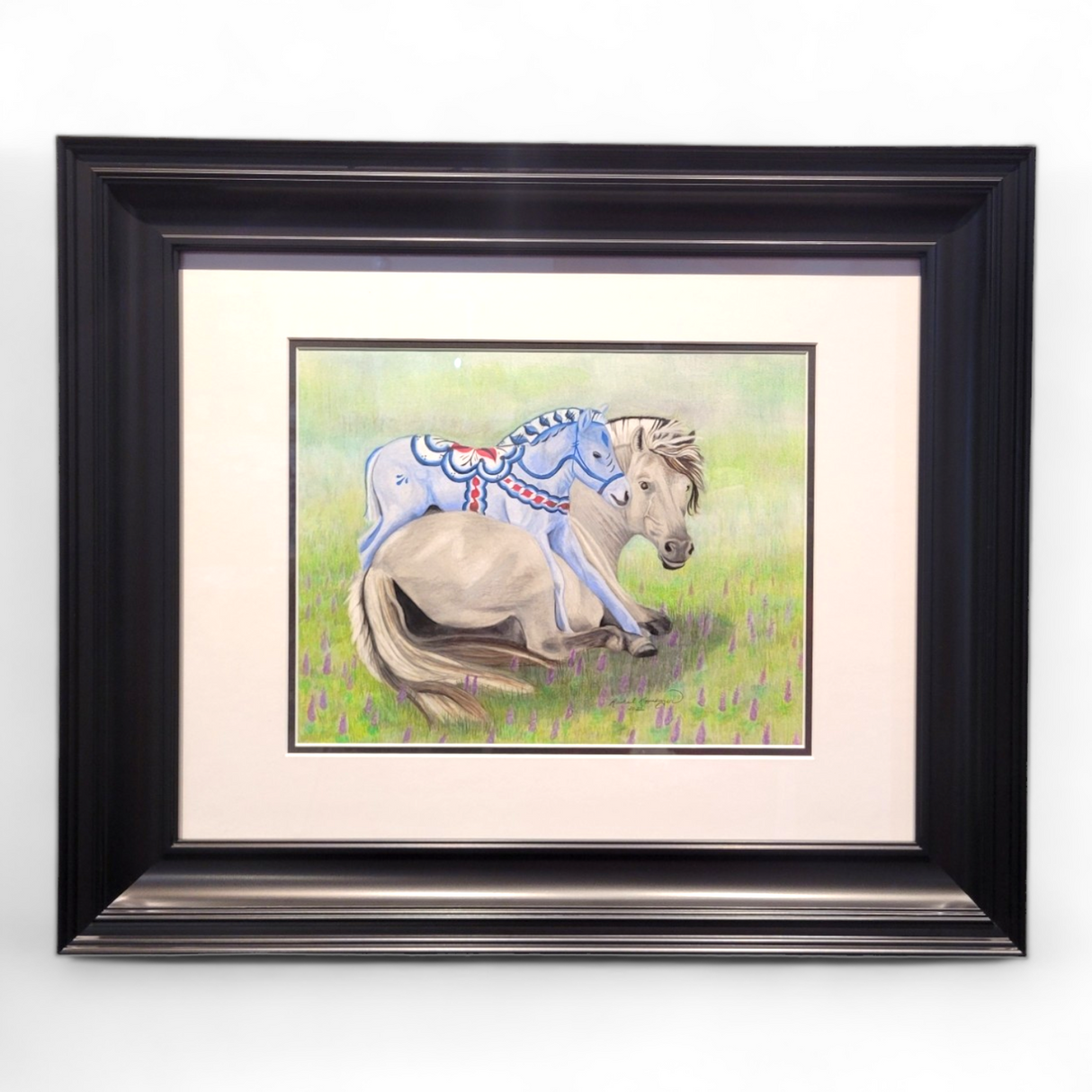 Framed painting titled "Fjord Foal Dala Horse" measuring 25x21, featuring a reclining Norwegian Fjord Horse adorned with artistic blue markings against a grassy background.