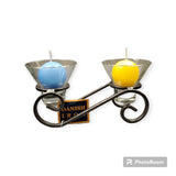 The Danish Iron Candle Holder, complete with two Leif glass cups for ball candles, exemplifies Scandinavian craftsmanship and modern elegance with its vibrant blue and yellow votive displays.