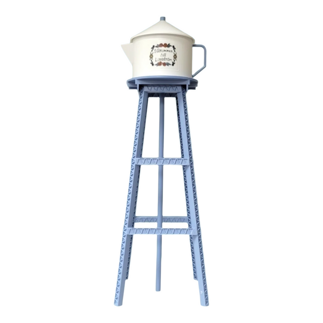 A tall blue metal stand supports a white teapot, resembling the Model Kit: Miniature Replica of the Lindström Coffee Pot Water Tower, set against a white background.