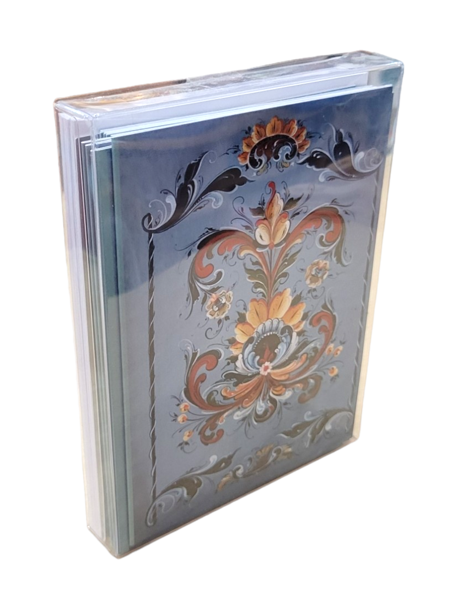 This decorative box, featuring a blue rosemaling floral design by Lise Lorentzen and a clear cover with a subtle reflective sheen, is ideal for storing the Card Pack: Blue Rosemaling (12-Pack) of blank greeting cards.