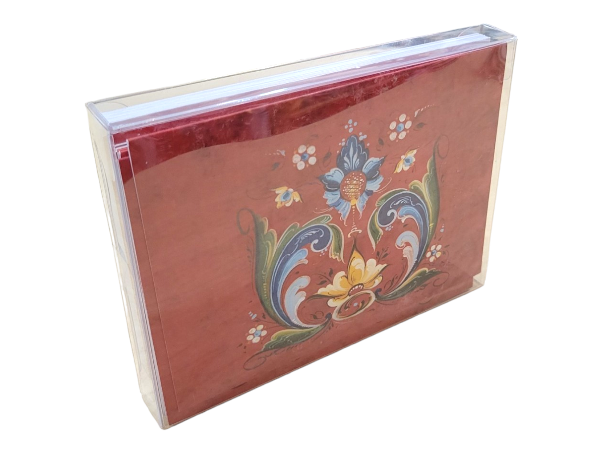 A decorative Card Pack featuring a Red Rosemaling design by Lise Lorentzen, including blank greeting cards with a floral cover and white envelopes, all encased in a clear plastic sleeve (12-Pack).